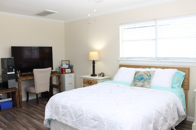 bedroom with visible vents, crown molding, and wood finished floors