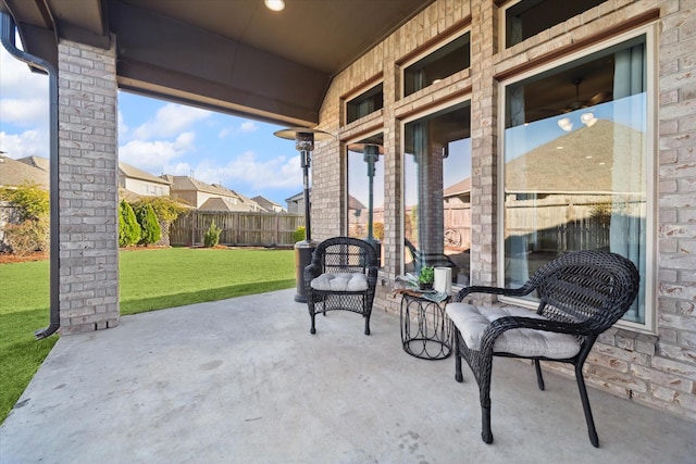 view of patio / terrace with fence and a residential view