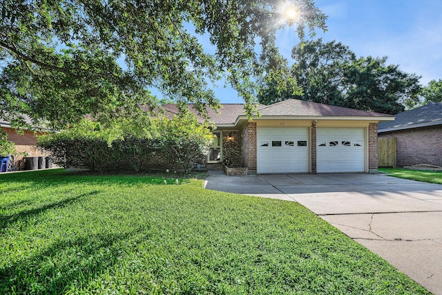 ranch-style home with an attached garage, brick siding, driveway, and a front yard