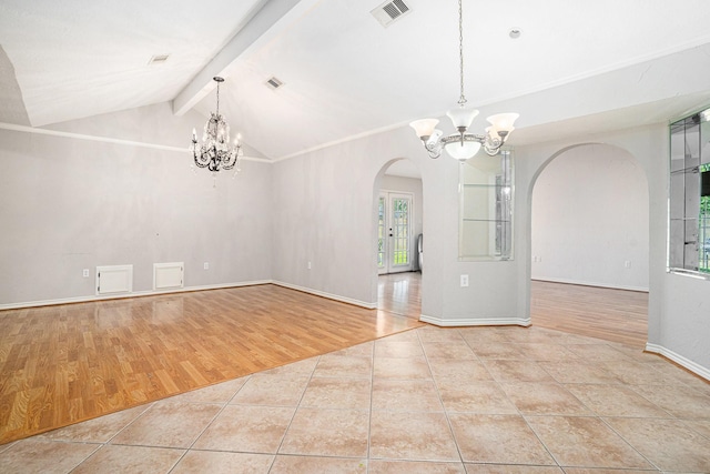 unfurnished dining area featuring an inviting chandelier, visible vents, tile patterned flooring, and arched walkways