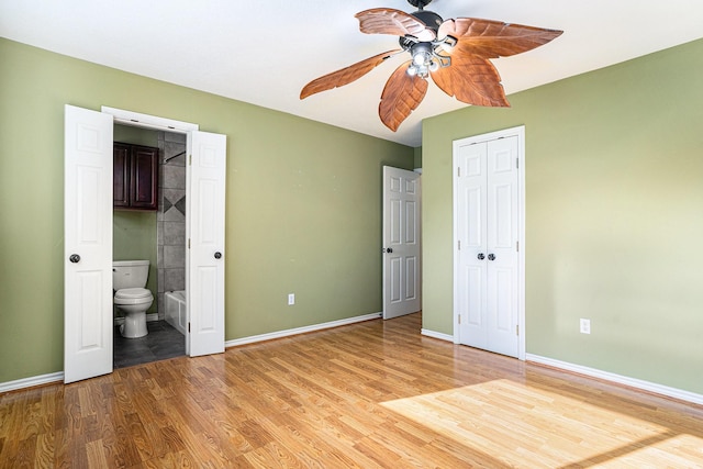 unfurnished bedroom featuring a closet, light wood-style flooring, and baseboards