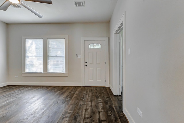 foyer with dark wood-type flooring, ceiling fan, and baseboards