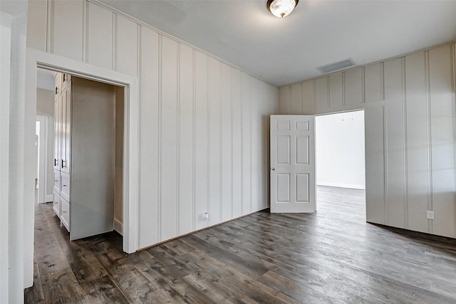 spare room featuring dark wood finished floors