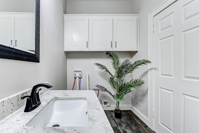 bathroom with a sink and wood finished floors