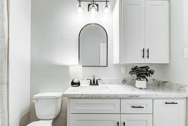 full bathroom featuring toilet and vanity