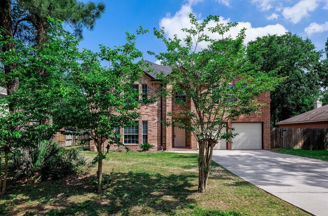 6902 Woodland Oaks, Magnolia, TX 77354 - view of front of home with fence, an attached garage, brick siding, and driveway