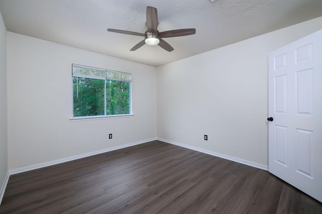 6902 Woodland Oaks, Magnolia, TX 77354 - spare room featuring a ceiling fan, baseboards, and dark wood-type flooring