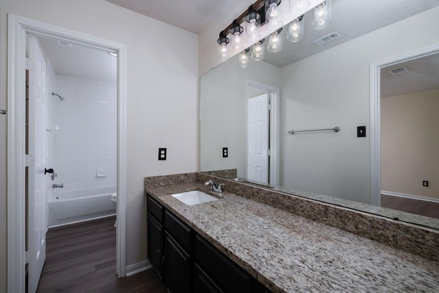 6902 Woodland Oaks, Magnolia, TX 77354 - full bath with visible vents, wood finished floors, vanity, and tub / shower combination