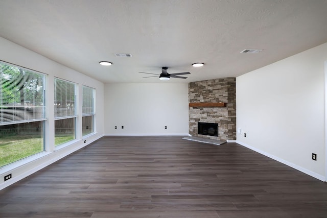 6902 Woodland Oaks, Magnolia, TX 77354 - unfurnished living room featuring a ceiling fan, baseboards, visible vents, and dark wood-style floors