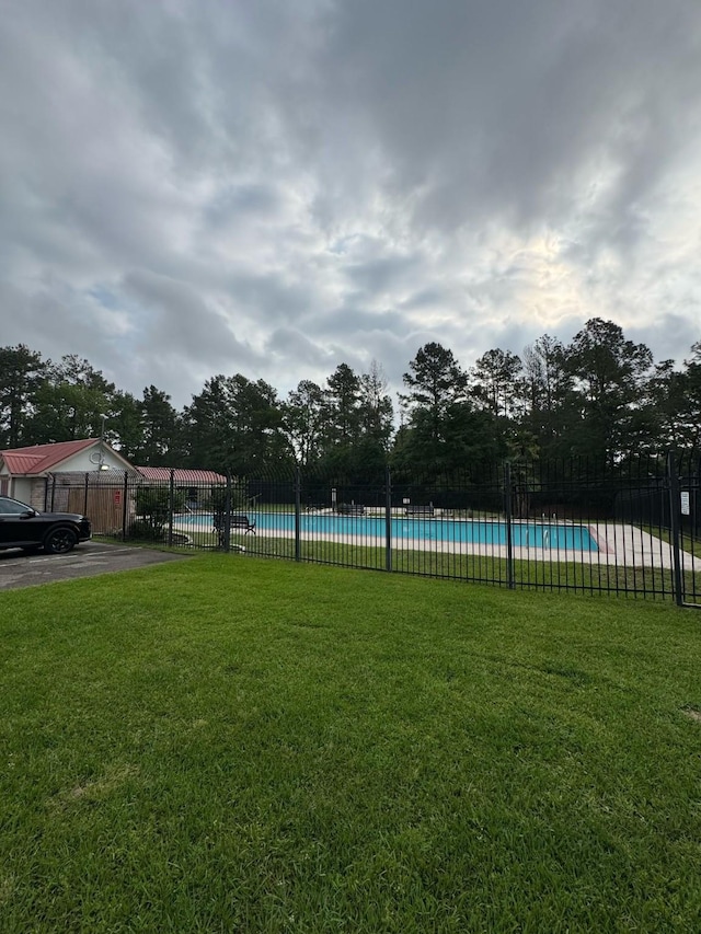 6902 Woodland Oaks, Magnolia, TX 77354 - view of yard with fence and a community pool
