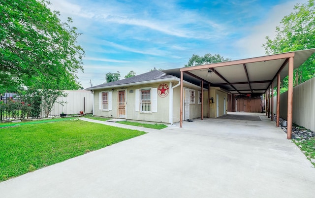 view of front of home with concrete driveway, a front yard, and fence
