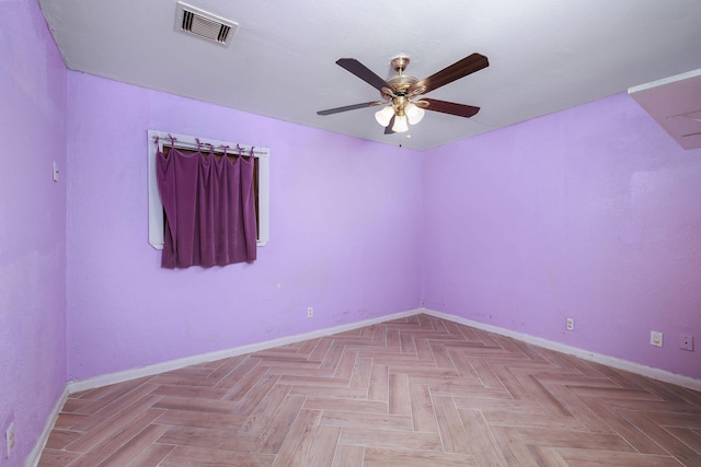 unfurnished room featuring visible vents, baseboards, and ceiling fan
