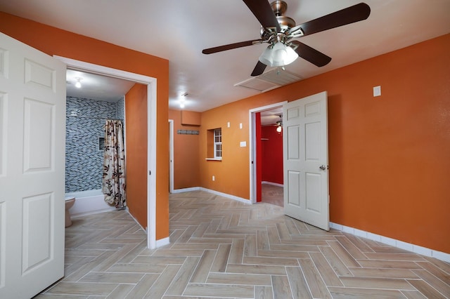 interior space with visible vents, baseboards, and ceiling fan