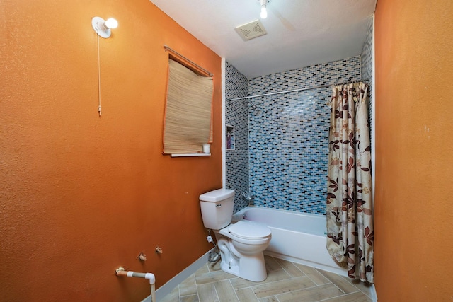 bathroom featuring toilet, baseboards, shower / bath combo, and visible vents