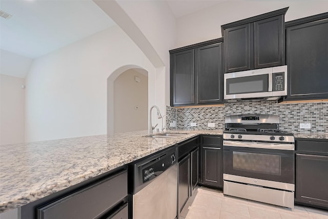 19911 Whistle Creek Ln, Cypress, TX 77433 - kitchen featuring a sink, light stone countertops, appliances with stainless steel finishes, tasteful backsplash, and light tile patterned flooring