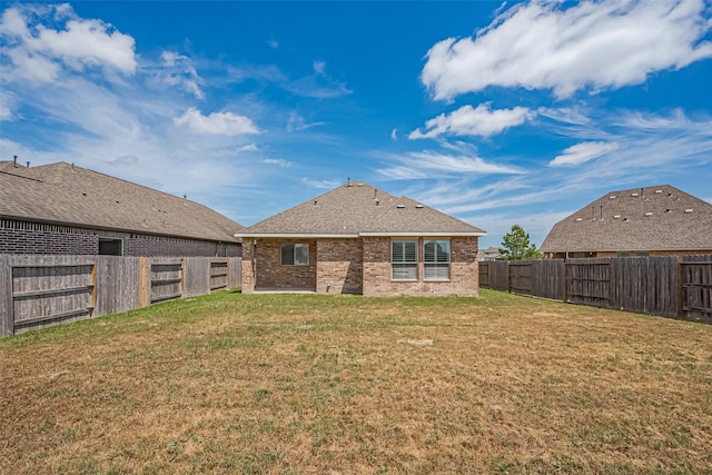 19911 Whistle Creek Ln, Cypress, TX 77433 - rear view of property featuring a yard, brick siding, and a fenced backyard