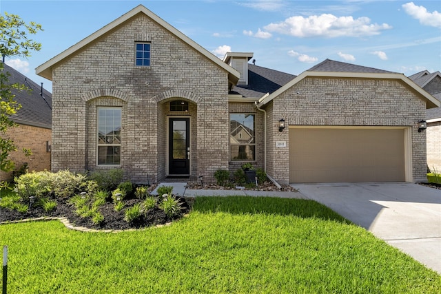 31811 Snapdragon Glen Trl, Hockley, TX 77447 - french country style house featuring a front lawn, brick siding, driveway, and a garage
