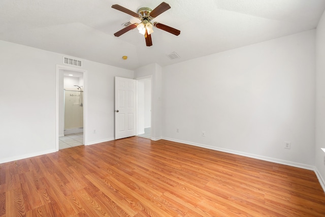 5315 Cilantro Ln, Baytown, TX 77521 - unfurnished bedroom with light wood-style flooring, baseboards, connected bathroom, and ceiling fan