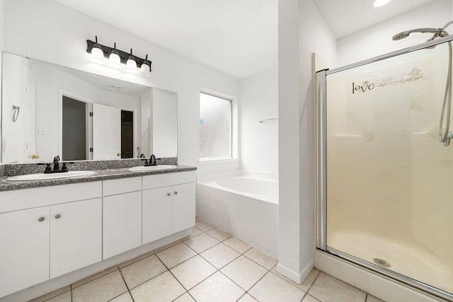 5315 Cilantro Ln, Baytown, TX 77521 - full bathroom with a stall shower, a bath, double vanity, and tile patterned flooring