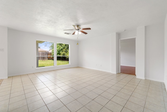 5315 Cilantro Ln, Baytown, TX 77521 - spare room with a ceiling fan, light tile patterned flooring, a textured ceiling, and baseboards