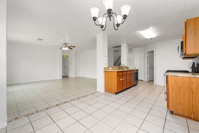 5315 Cilantro Ln, Baytown, TX 77521 - kitchen with appliances with stainless steel finishes, brown cabinetry, open floor plan, and light tile patterned floors
