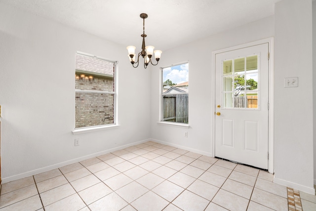 5315 Cilantro Ln, Baytown, TX 77521 - unfurnished dining area featuring a chandelier, light tile patterned floors, and baseboards