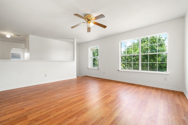 5315 Cilantro Ln, Baytown, TX 77521 - spare room featuring ceiling fan, light wood-style floors, and baseboards