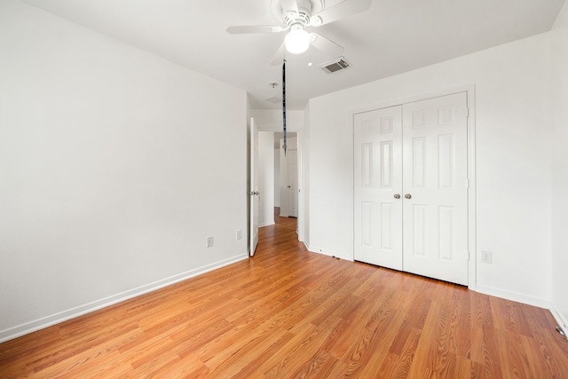 5315 Cilantro Ln, Baytown, TX 77521 - unfurnished bedroom with light wood-style flooring, baseboards, a closet, and a ceiling fan