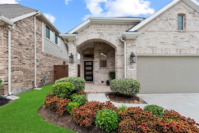 7015 Winterberry Glen Ln, Katy, TX 77493 - property entrance featuring concrete driveway, a yard, brick siding, and a garage