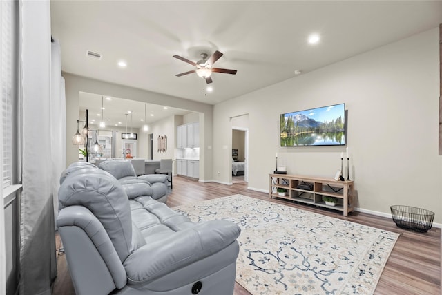 7015 Winterberry Glen Ln, Katy, TX 77493 - living area with light wood-type flooring, baseboards, ceiling fan, and recessed lighting