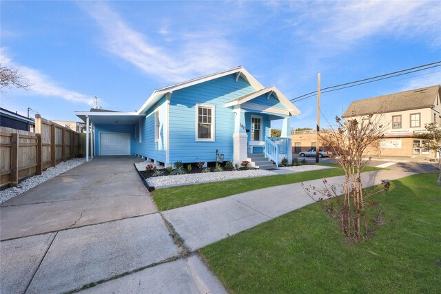 1802 Ursuline St, Galveston, TX 77550 - bungalow-style home featuring a porch, fence, concrete driveway, a garage, and a front yard