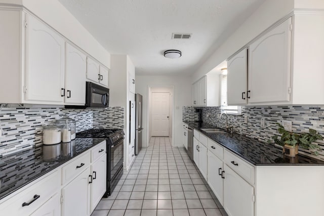 kitchen with black appliances, a sink, white cabinets, and decorative backsplash