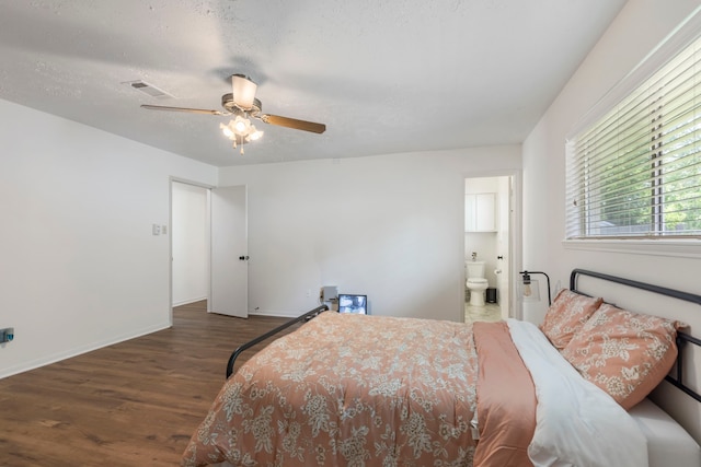 bedroom featuring wood finished floors, baseboards, connected bathroom, and ceiling fan
