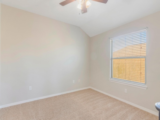 carpeted empty room with baseboards, lofted ceiling, and ceiling fan