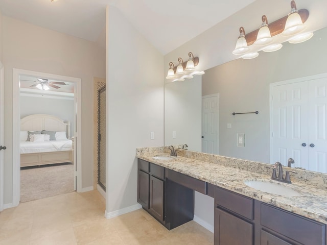bathroom with a sink, double vanity, a stall shower, and tile patterned flooring