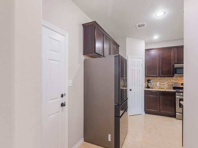 kitchen with light tile patterned flooring, visible vents, backsplash, dark brown cabinets, and appliances with stainless steel finishes