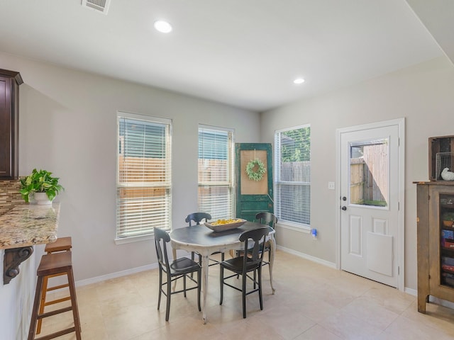 dining area with baseboards, light tile patterned floors, and recessed lighting