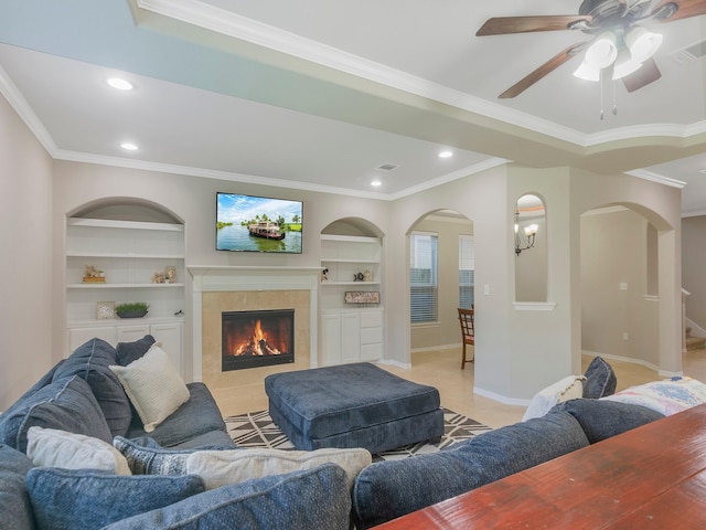 living area featuring recessed lighting, baseboards, ornamental molding, a tiled fireplace, and visible vents