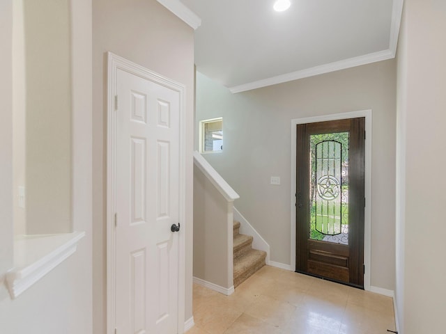 tiled entryway with baseboards, stairs, and ornamental molding