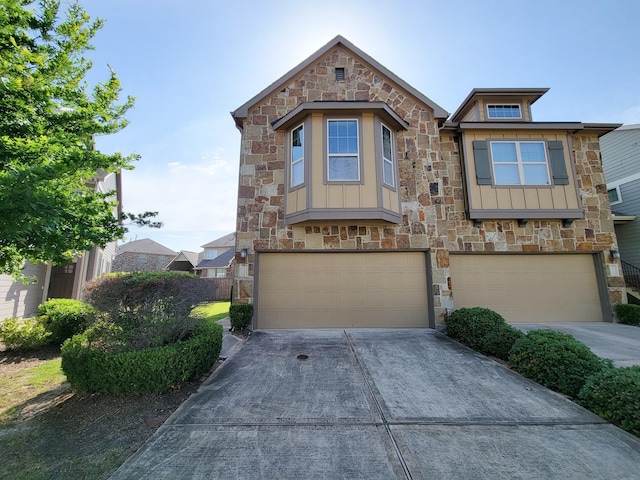 12111 San Luca St, Richmond, TX 77406 - view of front of house featuring stone siding, an attached garage, and board and batten siding