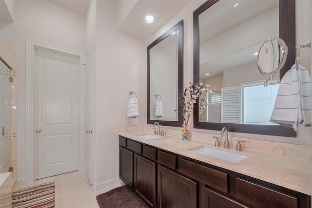 2303 Hadley St, Houston, TX 77003 - bathroom featuring a stall shower, double vanity, tile patterned flooring, and recessed lighting