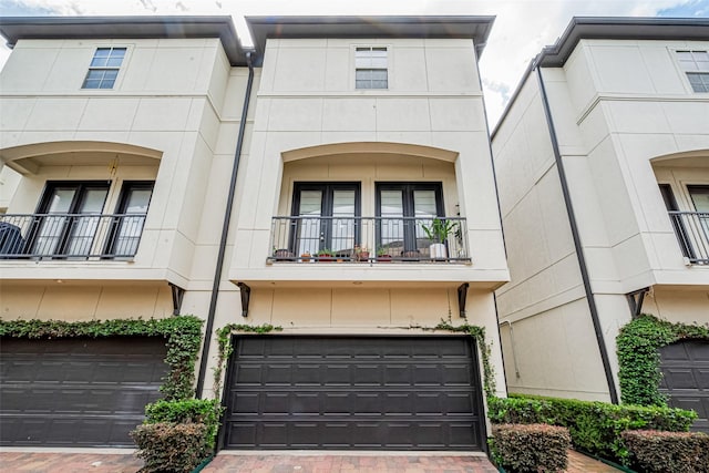 2303 Hadley St, Houston, TX 77003 - multi unit property with a garage, stucco siding, decorative driveway, and a balcony