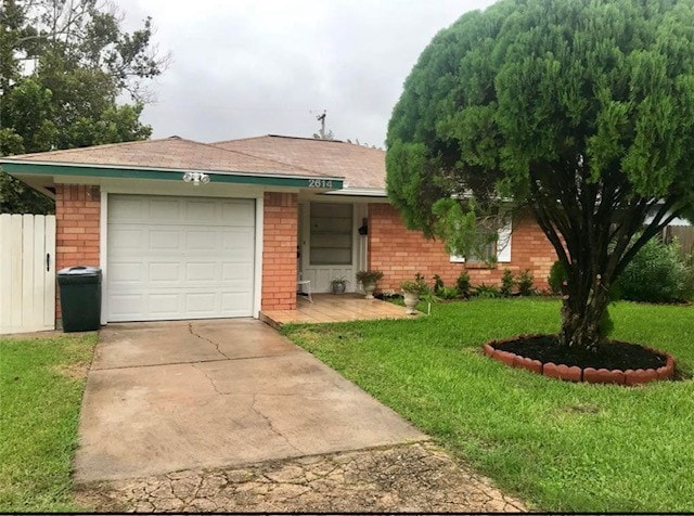 ranch-style house featuring driveway, brick siding, fence, an attached garage, and a front lawn