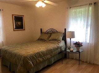 bedroom with ceiling fan and wood finished floors