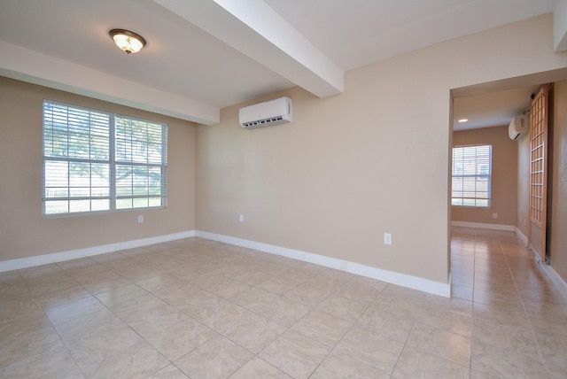 empty room with light tile patterned floors, baseboards, beam ceiling, and a wall unit AC