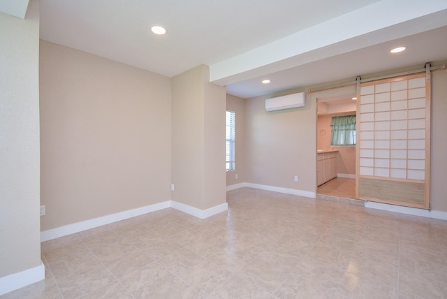 spare room with a wall mounted AC, a barn door, a healthy amount of sunlight, and recessed lighting