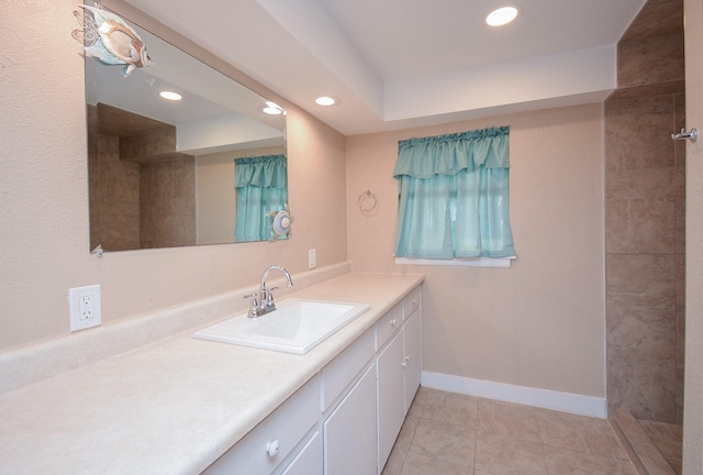 bathroom featuring baseboards, tile patterned flooring, vanity, and recessed lighting