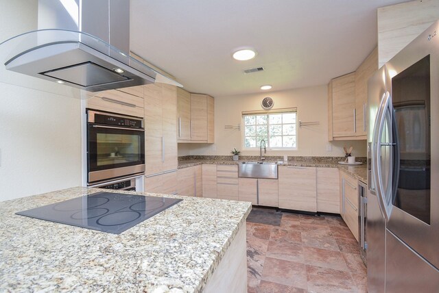 kitchen featuring a sink, light brown cabinets, island exhaust hood, and appliances with stainless steel finishes