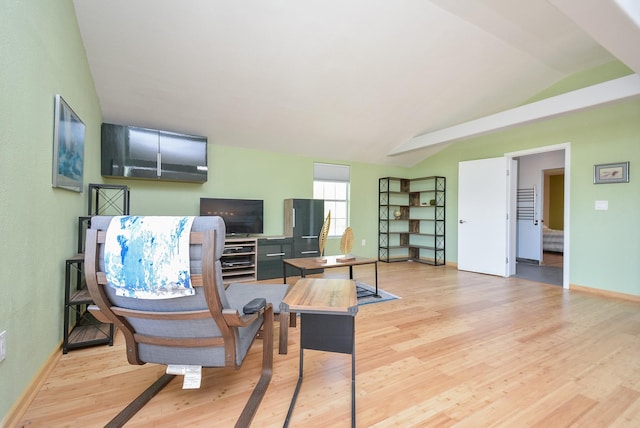 office space with lofted ceiling, light wood-style flooring, and baseboards