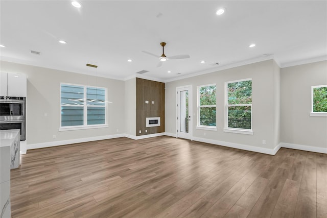 602 W 28th St Unit B, Houston, TX 77008 - unfurnished living room with crown molding, wood finished floors, baseboards, and ceiling fan